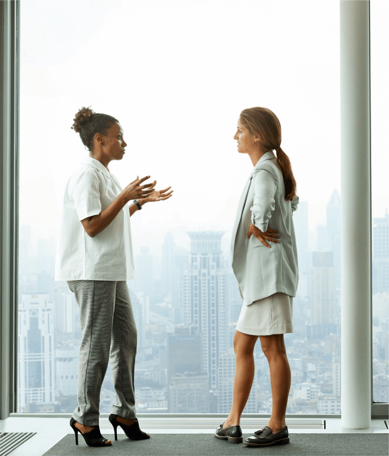 Two women coworkers talking in an office