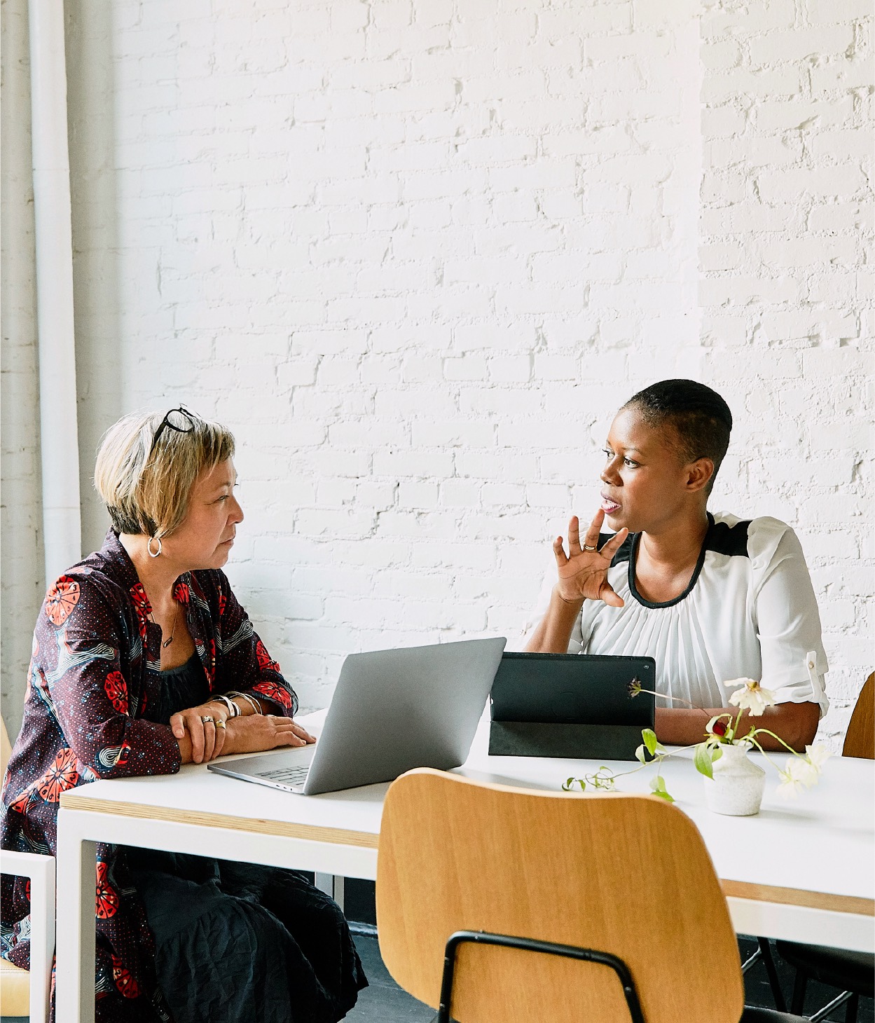 Two women discussing business in a conference room