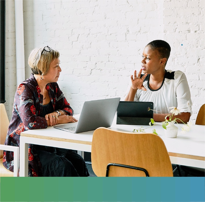 Two women discussing business in a conference room