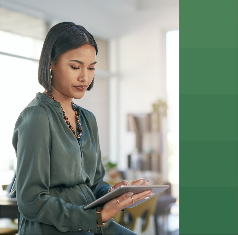 Woman works on her tablet in her office