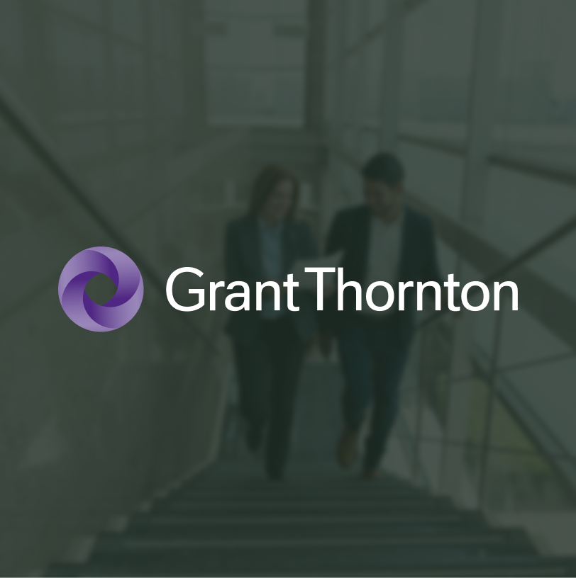 Grant Thornton logo atop a blurred photo of collegues walking up stairs